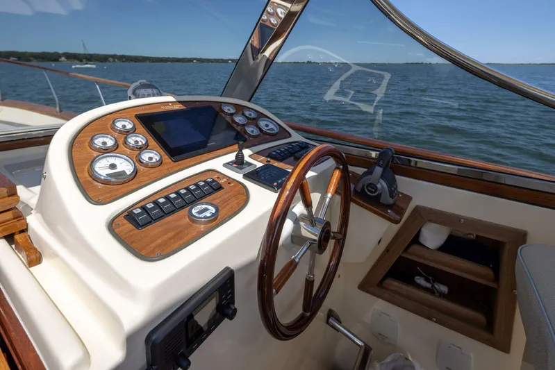  Yacht Photos Pics Fratelli Aprea 32 Hard Top 2022 boat helm with wooden dashboard and steering wheel.