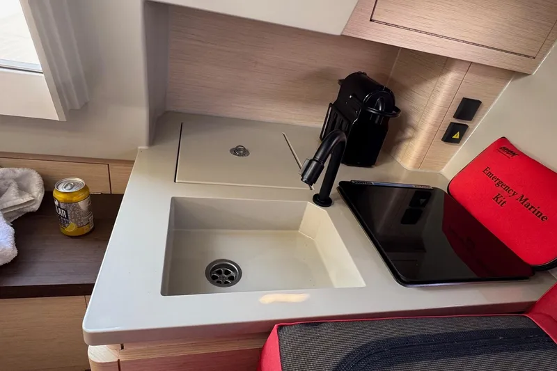 Sortie Yacht Photos Pics Compact kitchen area in 2023 Saffier 33 Life yacht with sink, coffee maker, and emergency kit.