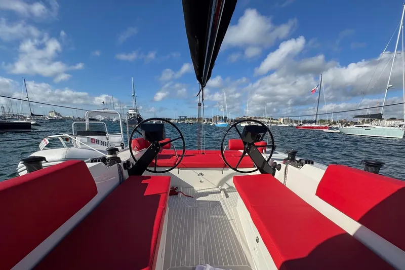 Sortie Yacht Photos Pics 2023 Saffier 33 Life sailboat with red seating, dual steering wheels, and scenic marina view.