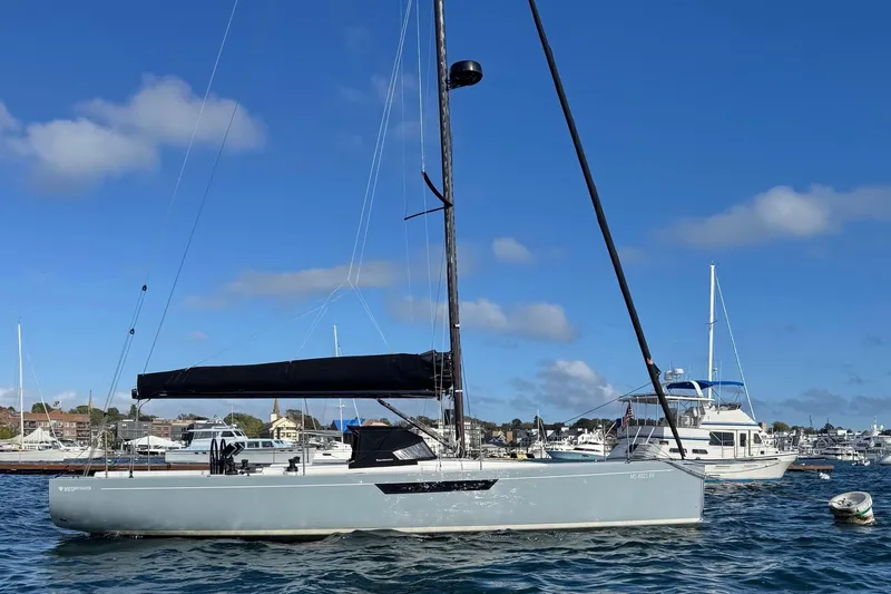 Sortie Yacht Photos Pics 2023 Saffier 33 Life sailboat on water, clear sky, marina background.