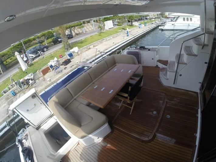  Yacht Photos Pics 2013 Princess 64 yacht with outdoor seating and table.