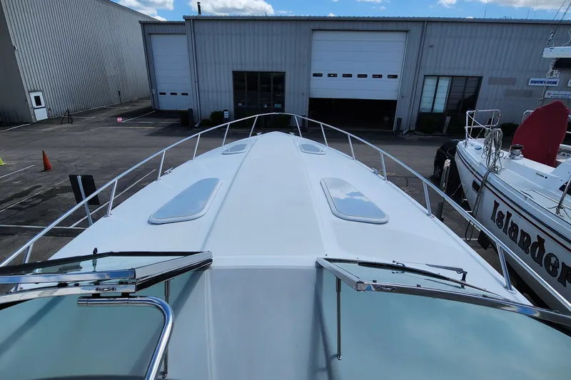 Reduced! Yacht Photos Pics 2005 Formula 400 Super Sport boat docked near industrial buildings.