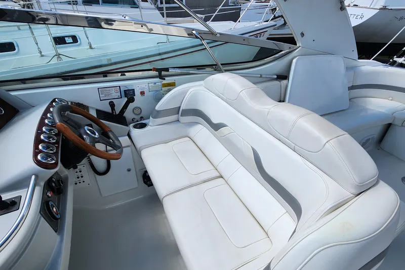 Reduced! Yacht Photos Pics 2005 Formula 400 Super Sport boat interior with white leather seating and wooden steering wheel.