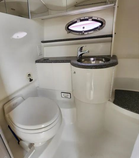 Reduced! Yacht Photos Pics 2005 Formula 400 Super Sport boat bathroom with sink, toilet, and porthole window.