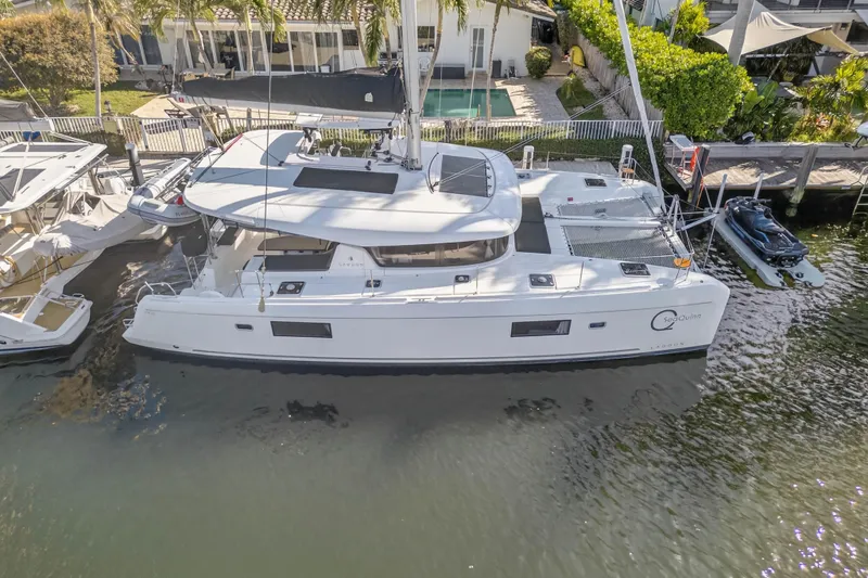 Seaquinn Yacht Photos Pics 2019 Lagoon 42 catamaran docked by waterfront home, aerial view.