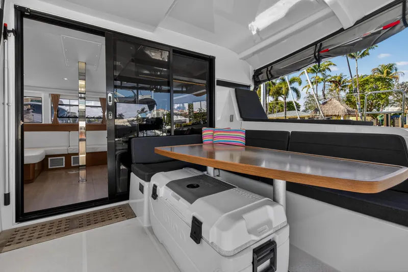 Seaquinn Yacht Photos Pics 2019 Lagoon 42 yacht interior with seating, table, and tropical view.