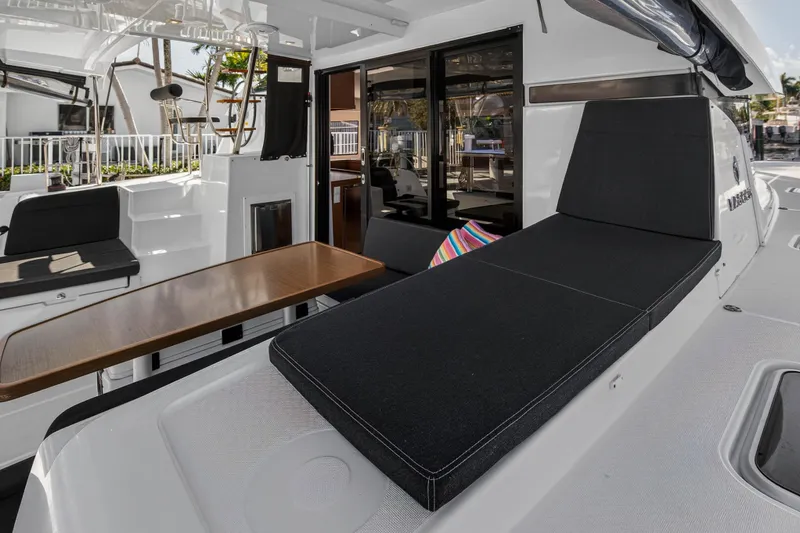Seaquinn Yacht Photos Pics 2019 Lagoon 42 yacht interior with sleek seating and wooden table.