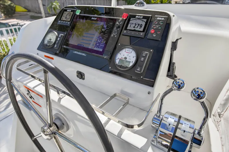 Seaquinn Yacht Photos Pics Steering console of 2019 Lagoon 42 catamaran with navigation instruments and controls.
