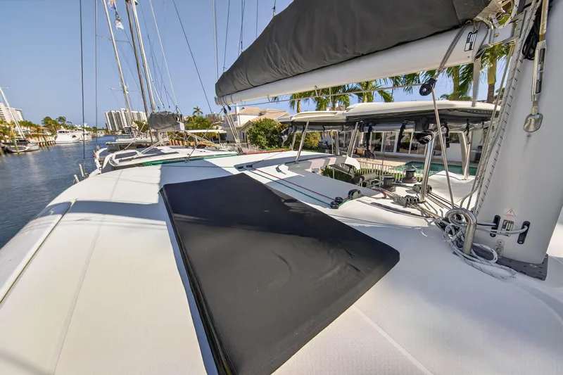 Seaquinn Yacht Photos Pics 2019 Lagoon 42 catamaran deck with sails, docked in a sunny marina.