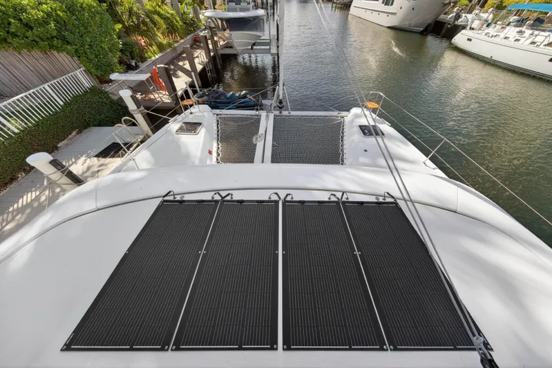 Seaquinn Yacht Photos Pics 2019 Lagoon 42 catamaran with solar panels docked in a marina.