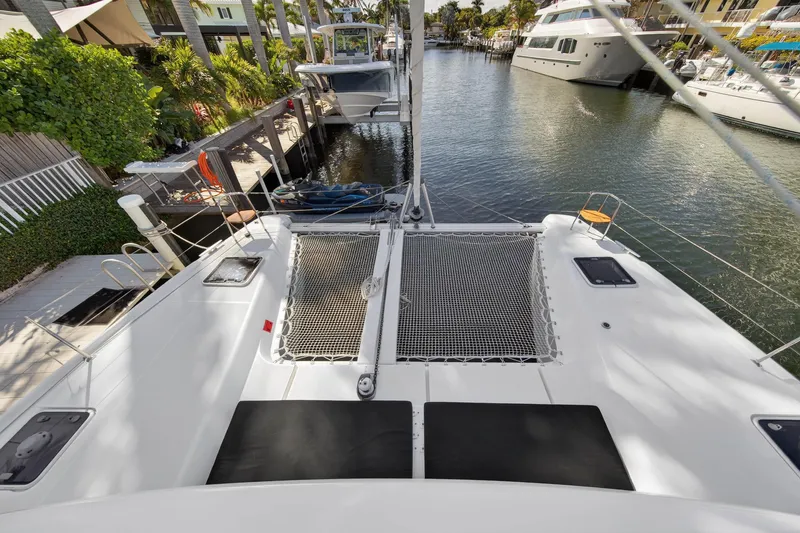 Seaquinn Yacht Photos Pics 2019 Lagoon 42 catamaran docked in a scenic marina setting.