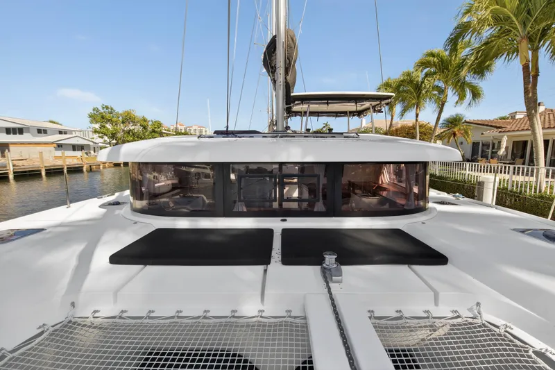 Seaquinn Yacht Photos Pics 2019 Lagoon 42 catamaran docked, featuring sleek design and spacious deck area.