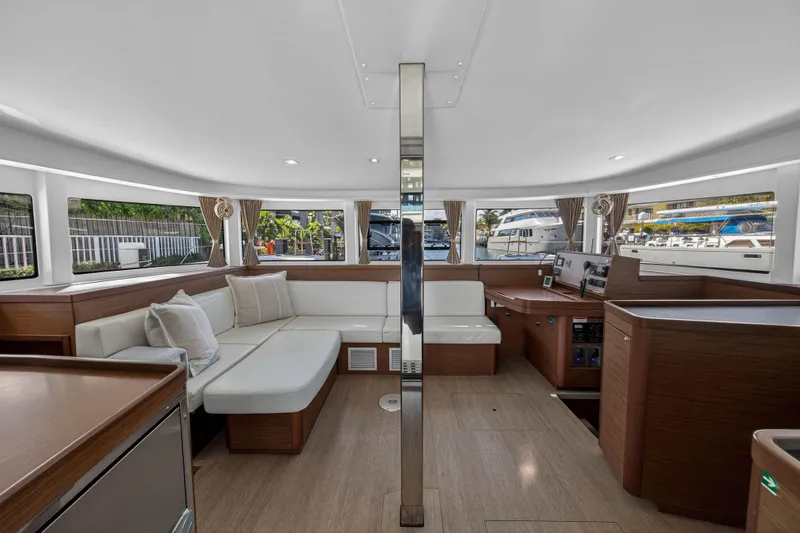 Seaquinn Yacht Photos Pics Luxurious interior of 2019 Lagoon 42 catamaran with modern seating and panoramic windows.