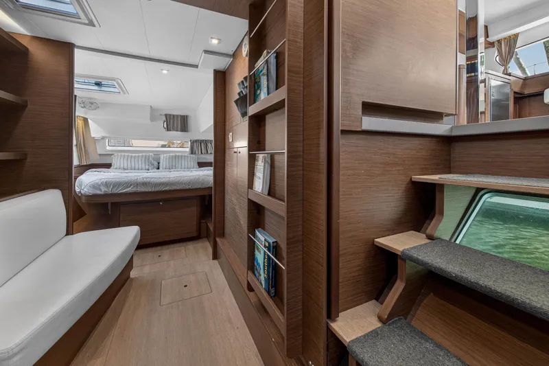 Seaquinn Yacht Photos Pics Interior of 2019 Lagoon 42 catamaran featuring cozy bedroom and modern wooden design.
