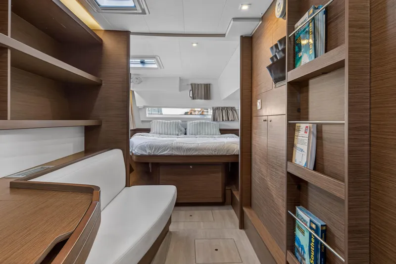 Seaquinn Yacht Photos Pics Luxurious interior of 2019 Lagoon 42 yacht with cozy bedroom and wooden furnishings.