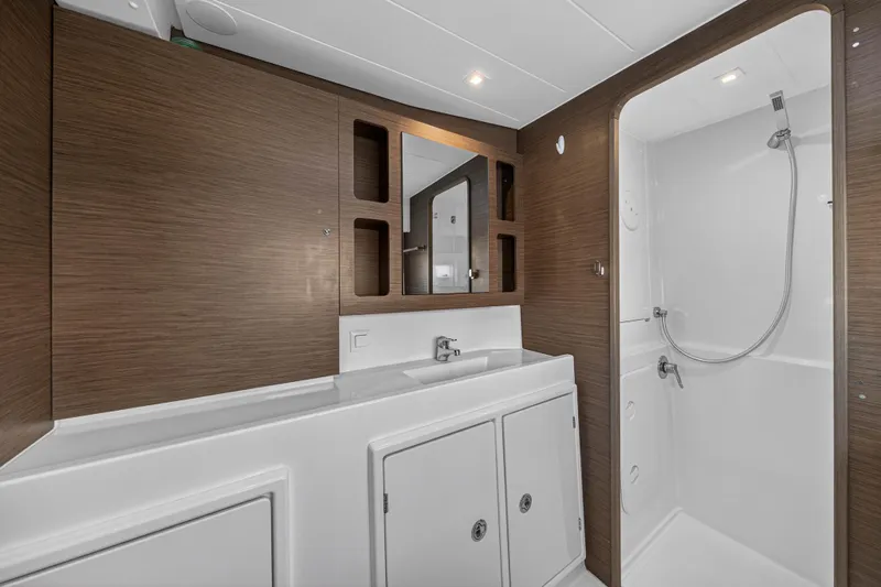 Seaquinn Yacht Photos Pics Modern bathroom interior of 2019 Lagoon 42 yacht with wood accents and shower.