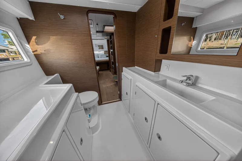Seaquinn Yacht Photos Pics Interior of 2019 Lagoon 42 yacht bathroom with modern fixtures and wood accents.