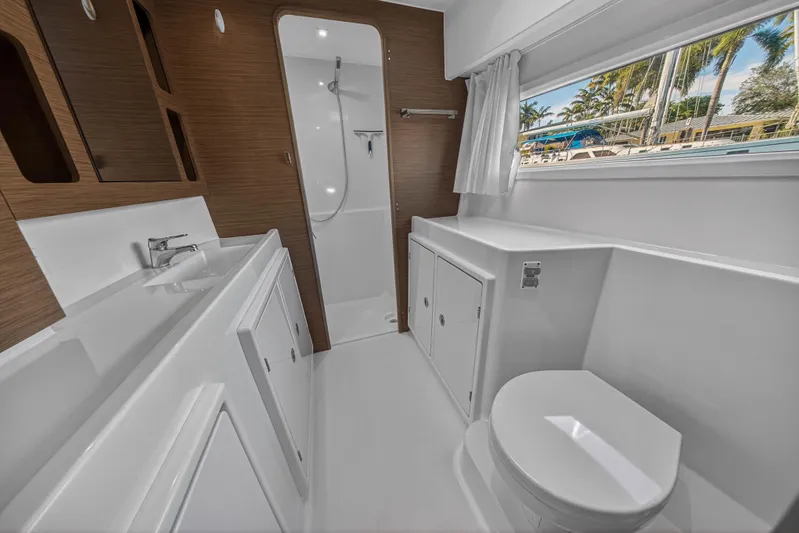 Seaquinn Yacht Photos Pics Luxurious bathroom interior of 2019 Lagoon 42 yacht with modern fixtures and wood accents.