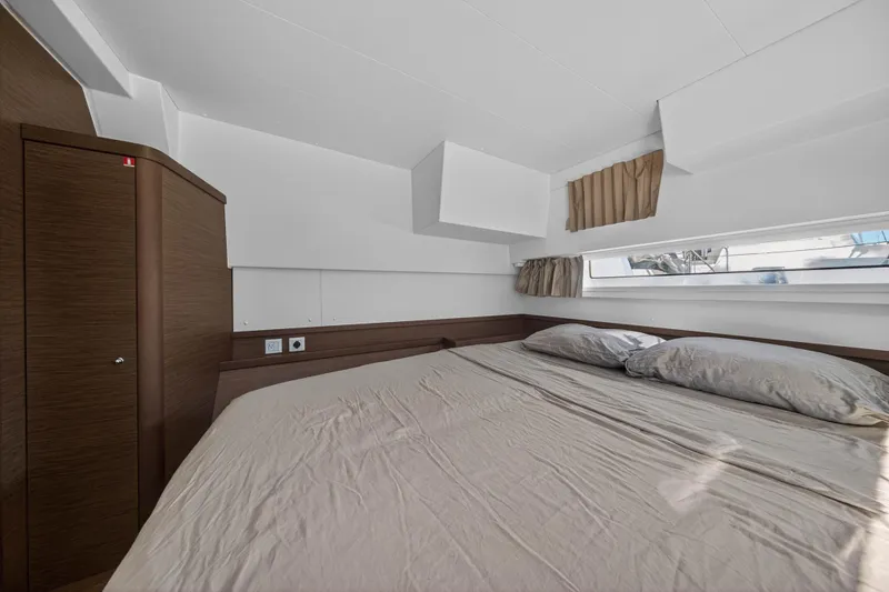 Seaquinn Yacht Photos Pics Interior cabin of 2019 Lagoon 42 catamaran with bed and window view.