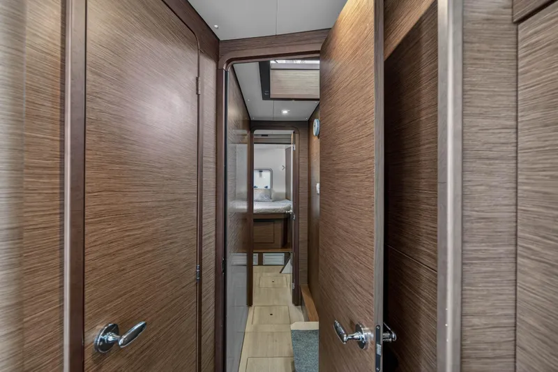 Seaquinn Yacht Photos Pics Interior hallway of 2019 Lagoon 42 yacht with wooden doors and modern design.