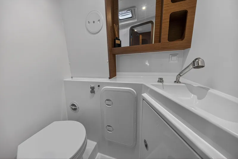 Seaquinn Yacht Photos Pics 2019 Lagoon 42 yacht bathroom with modern fixtures and wooden accents.