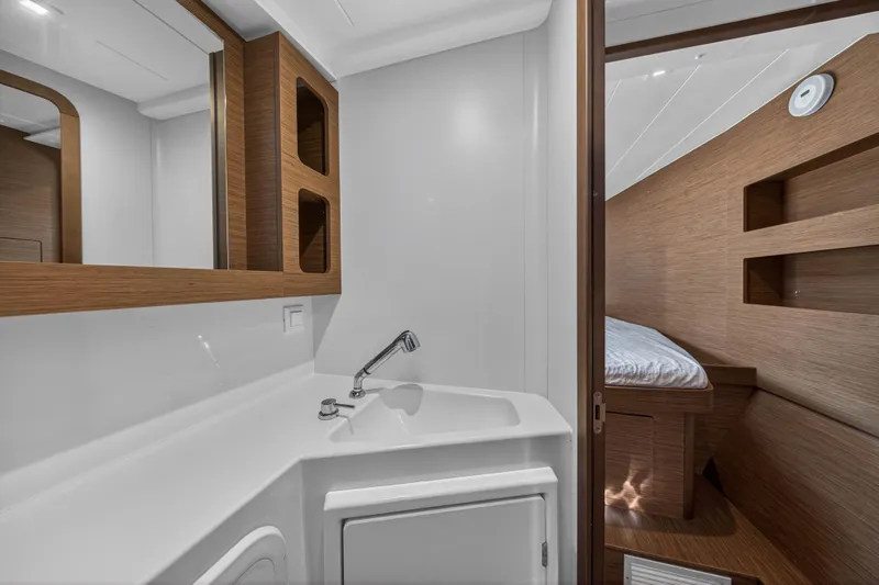Seaquinn Yacht Photos Pics Interior of 2019 Lagoon 42 yacht featuring a compact bathroom and cozy cabin.