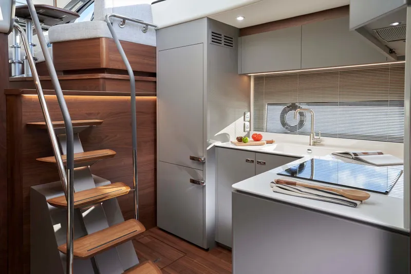 Princess V50 Yacht Photos Pics Modern kitchen interior of 2024 Princess V50 yacht with sleek design and wooden accents.