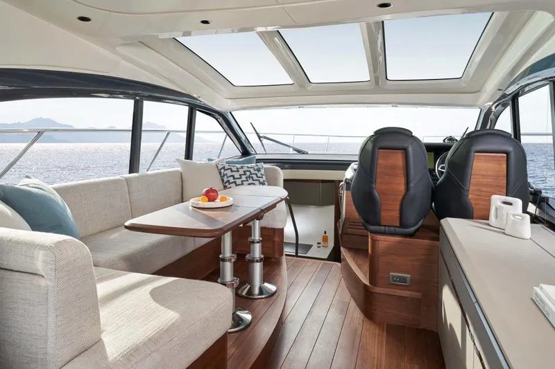 Princess V50 Yacht Photos Pics Luxurious interior of 2024 Princess V50 yacht with elegant seating and panoramic windows.