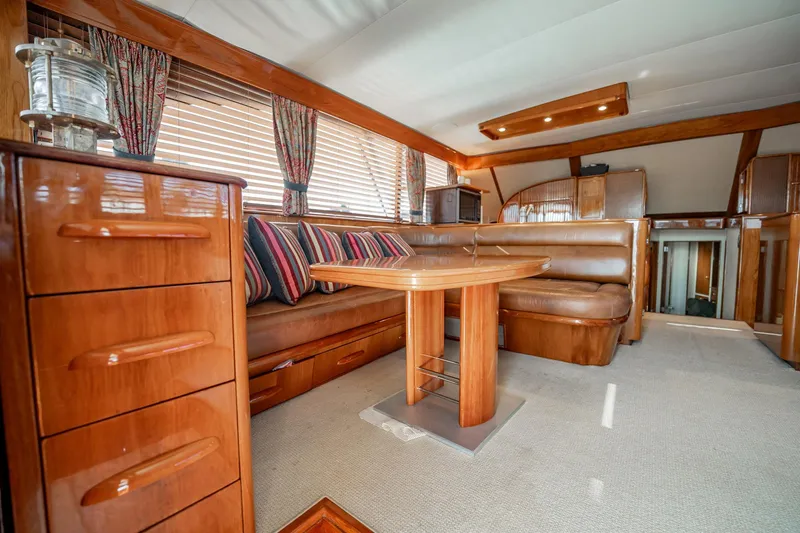Lucky Yacht Photos Pics Luxurious interior of a 1983 Rybovich 55 Convertible yacht with wood finishes and seating.
