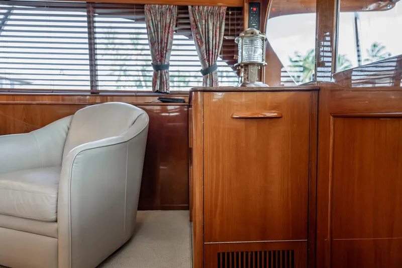 Lucky Yacht Photos Pics Interior of 1983 Rybovich 55 Convertible yacht with wooden cabinetry and leather chair.