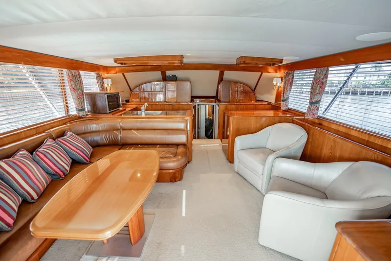Lucky Yacht Photos Pics Luxurious interior of 1983 Rybovich 55 Convertible yacht with leather seating and wood accents.