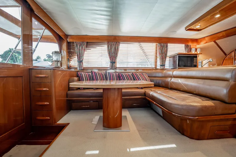 Lucky Yacht Photos Pics Luxurious interior of 1983 Rybovich 55 Convertible yacht with leather seating and wooden accents.