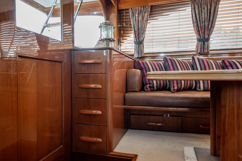 Lucky Yacht Photos Pics Interior of 1983 Rybovich 55 Convertible yacht with wood finish and striped cushions.
