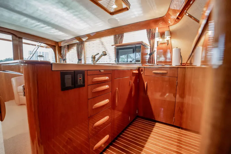 Lucky Yacht Photos Pics Luxurious wooden interior of 1983 Rybovich 55 Convertible yacht kitchen area.