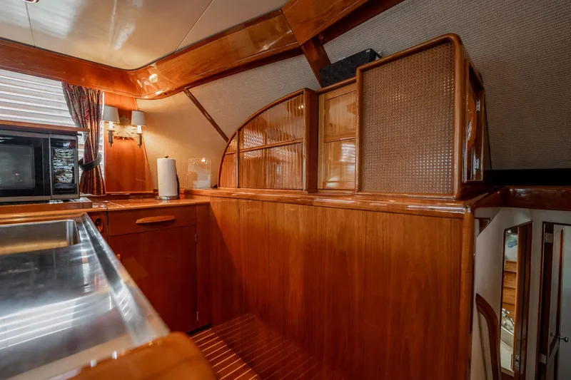 Lucky Yacht Photos Pics Luxurious wooden interior of a 1983 Rybovich 55 Convertible yacht kitchen area.