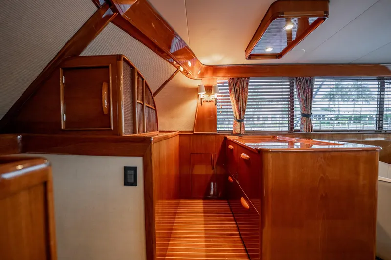 Lucky Yacht Photos Pics Luxurious wooden interior of a 1983 Rybovich 55 Convertible yacht with elegant cabinetry.