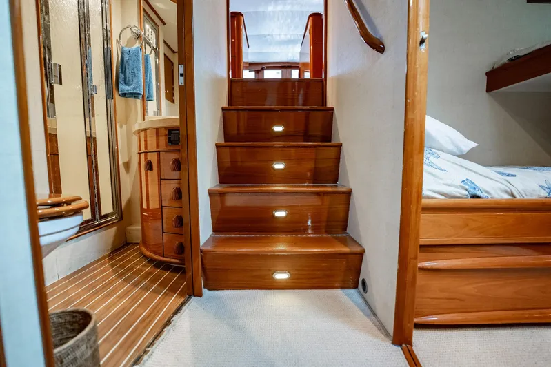 Lucky Yacht Photos Pics Interior of 1983 Rybovich 55 Convertible yacht with wooden stairs and cozy cabin.