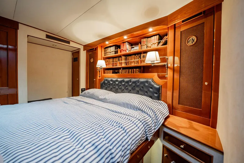 Lucky Yacht Photos Pics Luxurious cabin interior of 1983 Rybovich 55 Convertible yacht with elegant woodwork and cozy bedding.