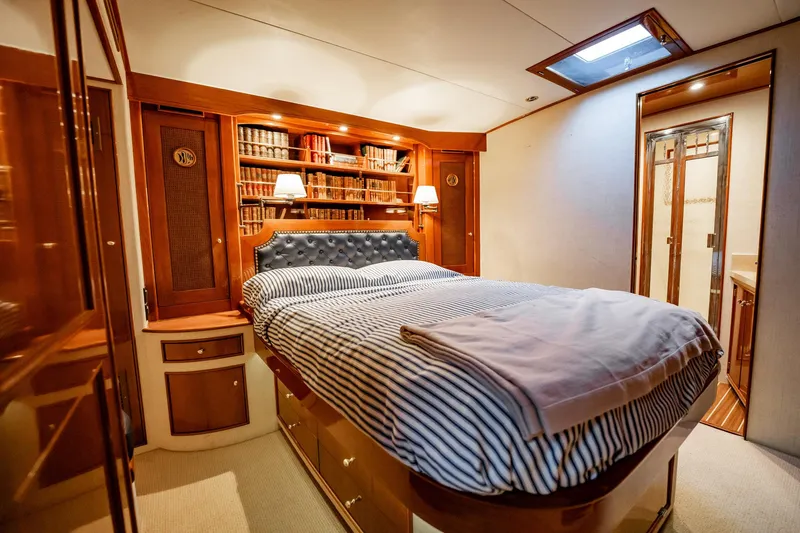 Lucky Yacht Photos Pics Luxurious cabin interior of 1983 Rybovich 55 Convertible yacht with cozy bed and wooden decor.