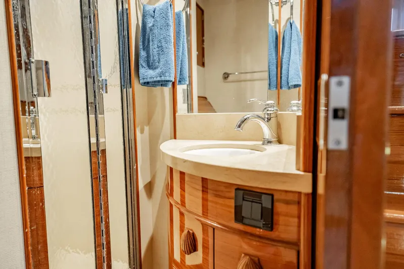 Lucky Yacht Photos Pics Luxurious bathroom interior of 1983 Rybovich 55 Convertible yacht with wooden accents.