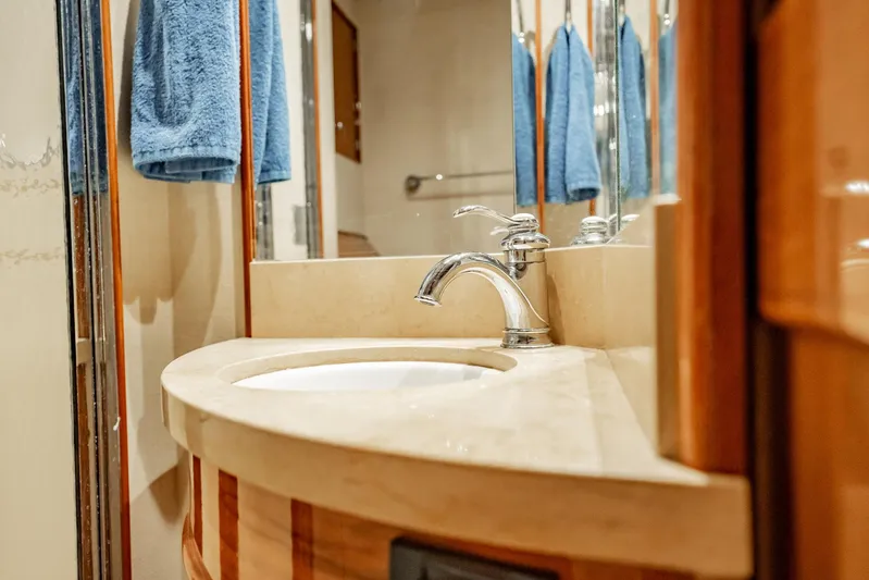 Lucky Yacht Photos Pics Luxurious bathroom sink on 1983 Rybovich 55 Convertible yacht with blue towels.