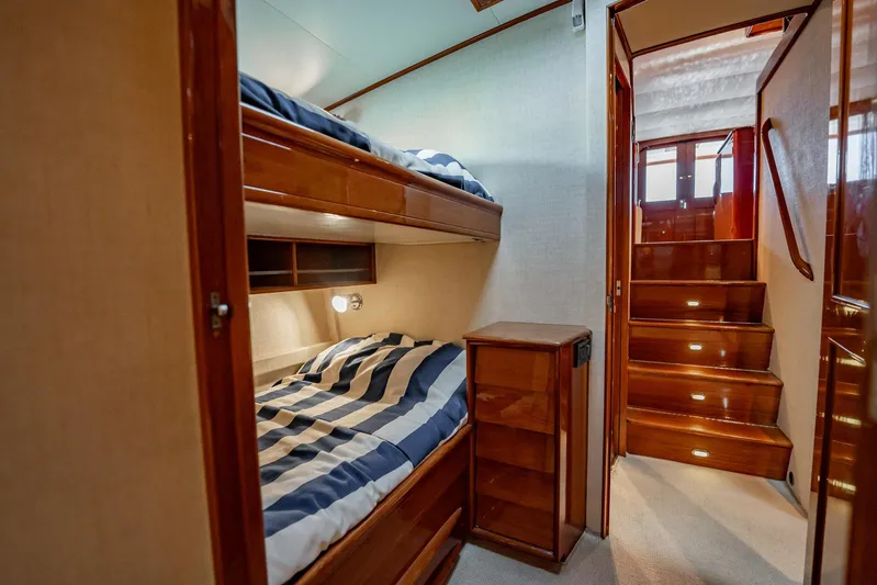 Lucky Yacht Photos Pics Interior of 1983 Rybovich 55 Convertible yacht with bunk beds and wooden stairs.