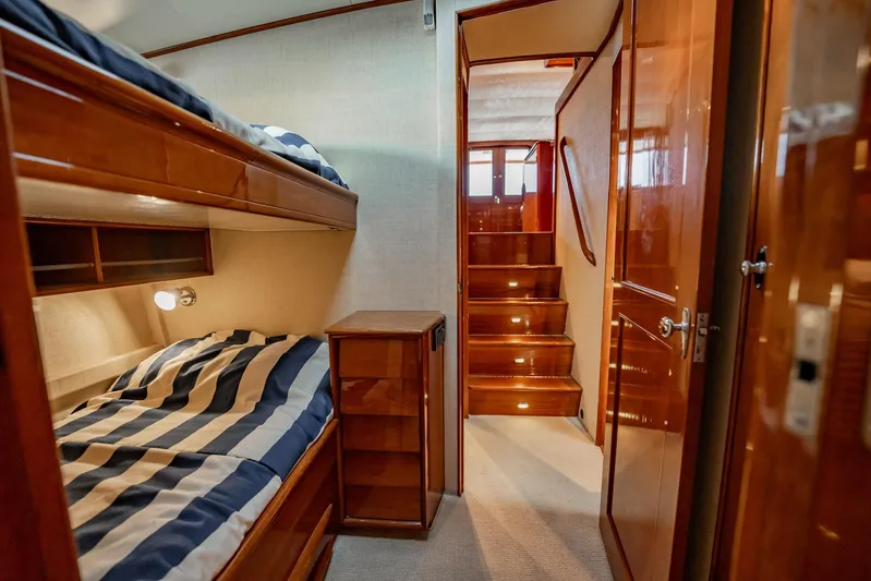 Lucky Yacht Photos Pics Interior of 1983 Rybovich 55 Convertible yacht with bunk beds and wooden stairs.