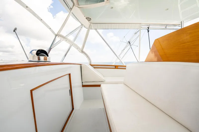 Lucky Yacht Photos Pics Interior of 1983 Rybovich 55 Convertible yacht with white seating and wooden accents.