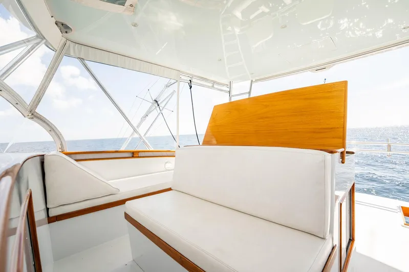 Lucky Yacht Photos Pics 1983 Rybovich 55 Convertible yacht interior with white seating and ocean view.