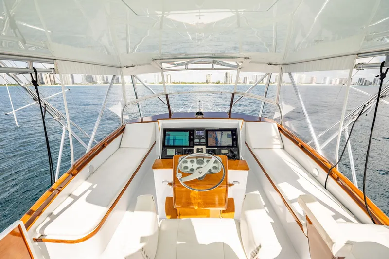 Lucky Yacht Photos Pics 1983 Rybovich 55 Convertible yacht helm with ocean view and modern navigation equipment.