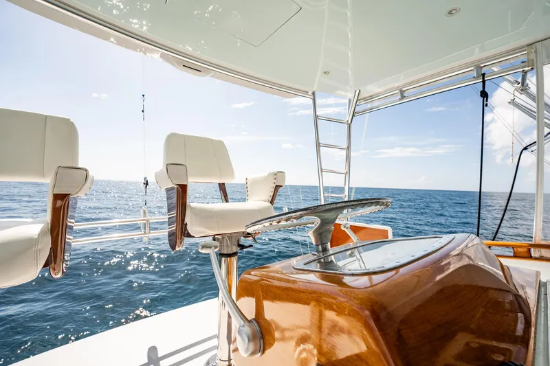 Lucky Yacht Photos Pics 1983 Rybovich 55 Convertible yacht interior with ocean view, featuring helm and seating.
