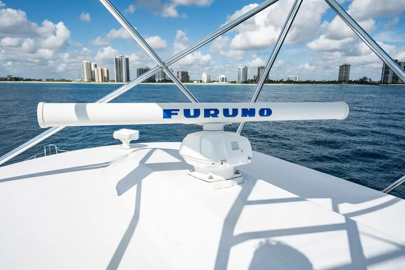 Lucky Yacht Photos Pics 1983 Rybovich 55 Convertible yacht with Furuno radar, ocean view, city skyline in background.
