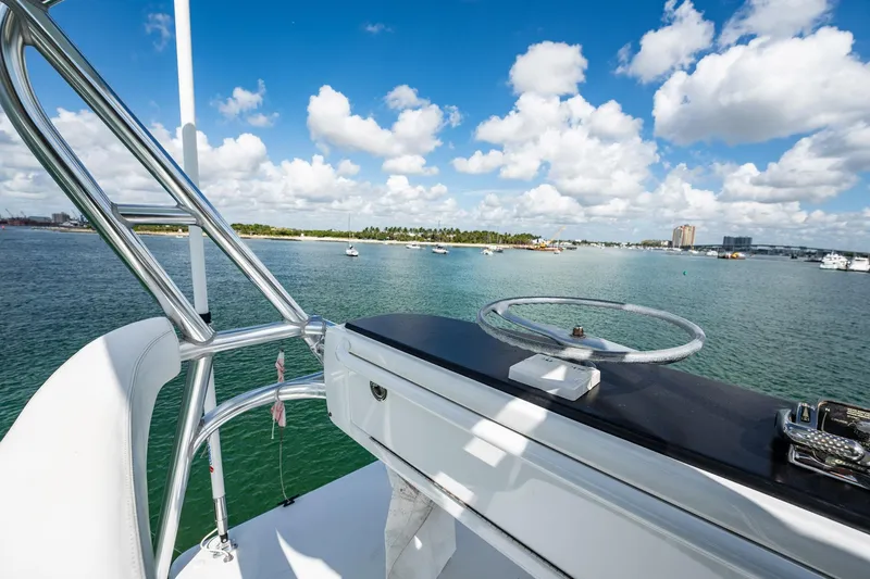 Lucky Yacht Photos Pics 1983 Rybovich 55 Convertible yacht helm with ocean view and blue sky.