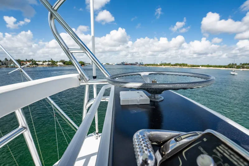Lucky Yacht Photos Pics 1983 Rybovich 55 Convertible yacht helm with ocean view and blue sky.